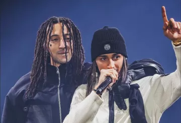 Deux artistes sur scène, l'un avec des dreadlocks, l'autre avec un bonnet, micro à la main.