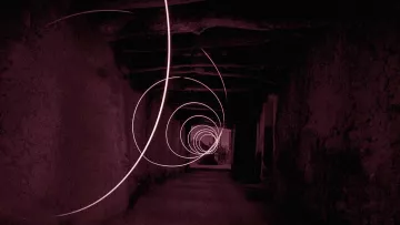 The image depicts a long, seemingly dark corridor with a series of swirling light trails creating a spiral effect. The color tone is predominantly red, contributing to a mysterious and somewhat surreal atmosphere. The walls of the corridor appear rough and textured, enhancing the sense of depth and perspective as the light trails guide the eye towards the far end of the hallway. The overall composition evokes a feeling of motion and intrigue.